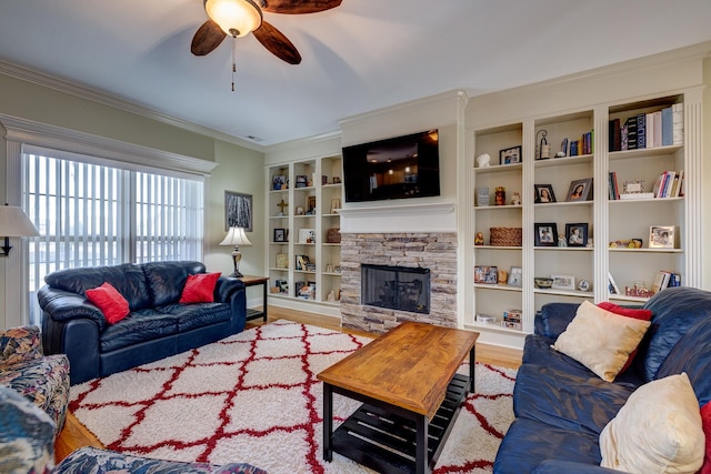 living room featuring a fireplace, wood-type flooring, ceiling fan, and crown molding