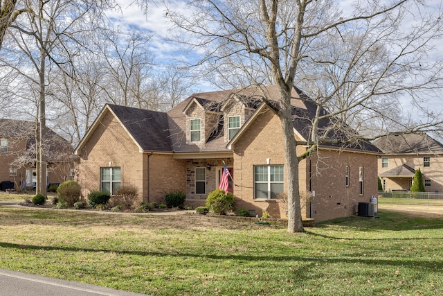 view of front of house with central AC and a front yard