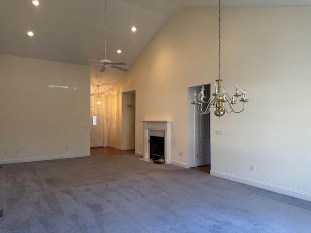 unfurnished living room with carpet, ceiling fan, and high vaulted ceiling