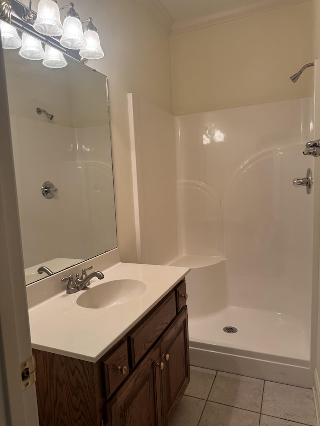 bathroom with tile patterned flooring, vanity, walk in shower, and crown molding