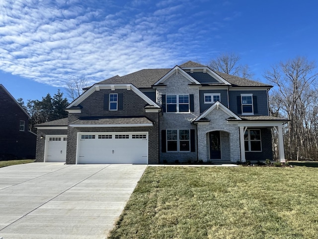 view of front of property with a front yard and a garage