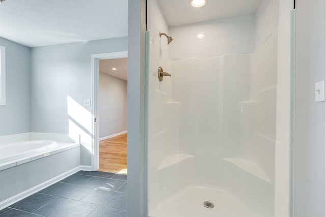 bathroom featuring plus walk in shower and tile patterned flooring