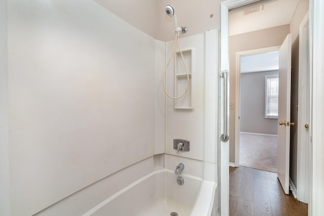 bathroom with hardwood / wood-style flooring and shower with separate bathtub