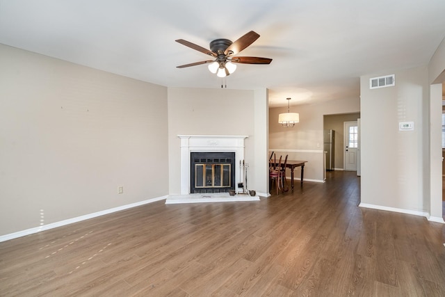 unfurnished living room with wood-type flooring and ceiling fan