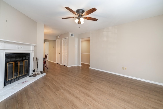 unfurnished living room featuring light hardwood / wood-style flooring and ceiling fan