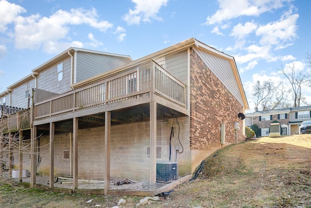 back of house with cooling unit and a deck