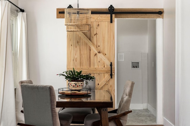 dining space featuring a barn door