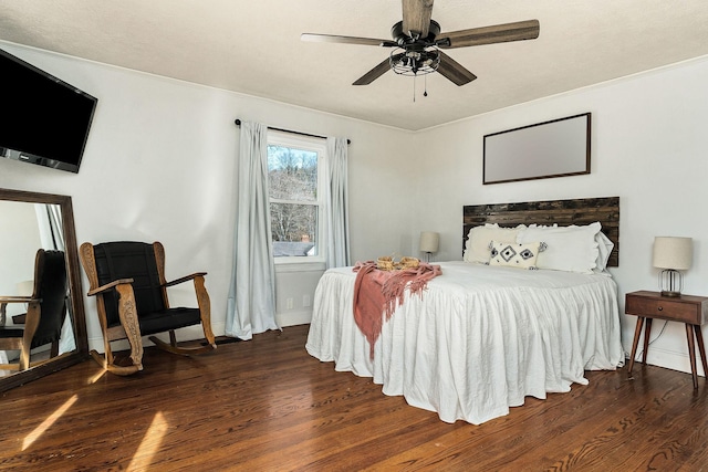 bedroom with ceiling fan, ornamental molding, and dark hardwood / wood-style flooring