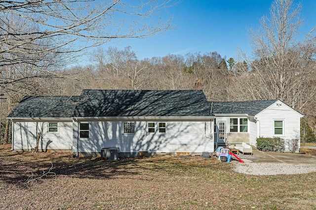 back of property with a yard and a patio