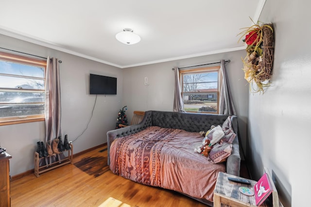 bedroom featuring crown molding and wood-type flooring