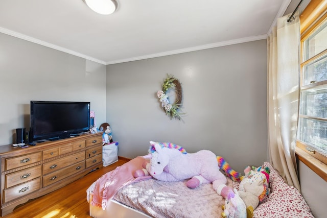 bedroom featuring wood-type flooring and ornamental molding