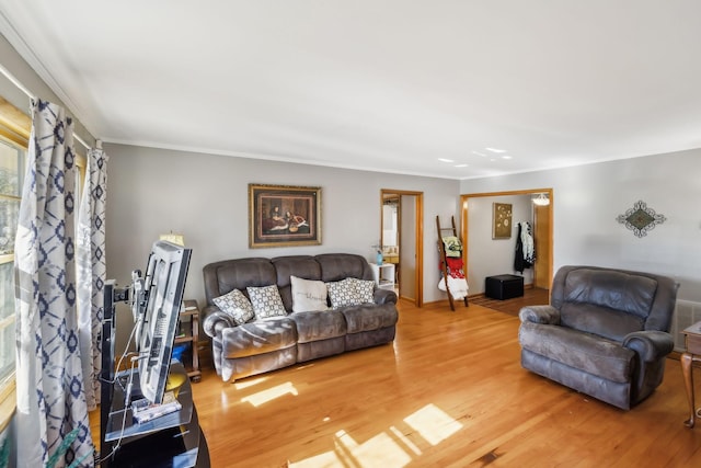 living room featuring hardwood / wood-style floors and ornamental molding