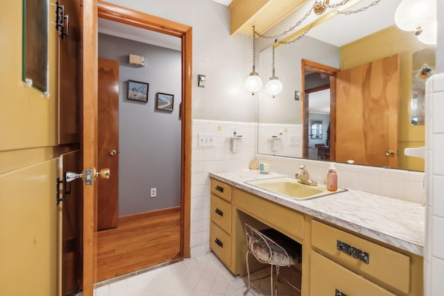 bathroom with tile patterned flooring, vanity, and tile walls