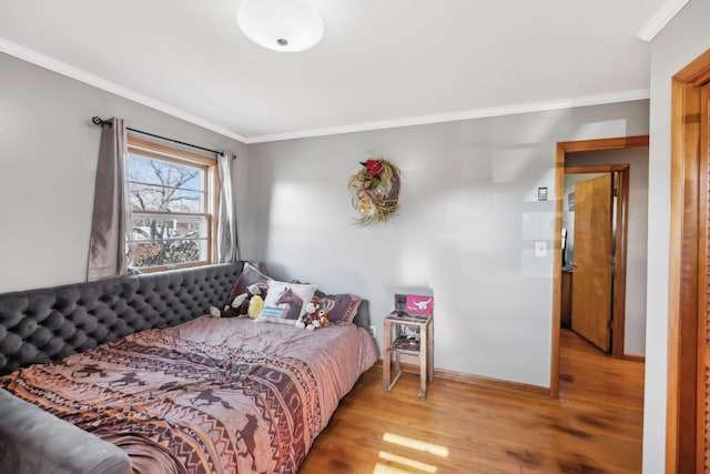 bedroom with wood-type flooring and ornamental molding