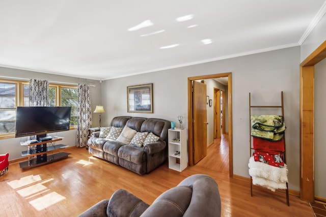 living room featuring light hardwood / wood-style floors and crown molding