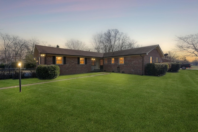 ranch-style house featuring a yard