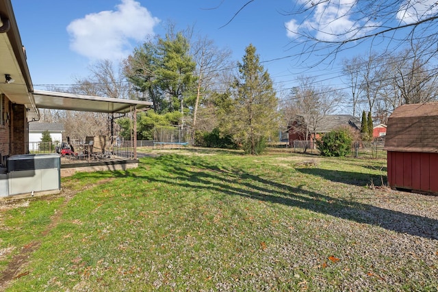 view of yard with cooling unit, a patio, and a trampoline