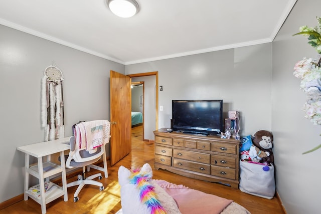 bedroom with ornamental molding and light hardwood / wood-style flooring