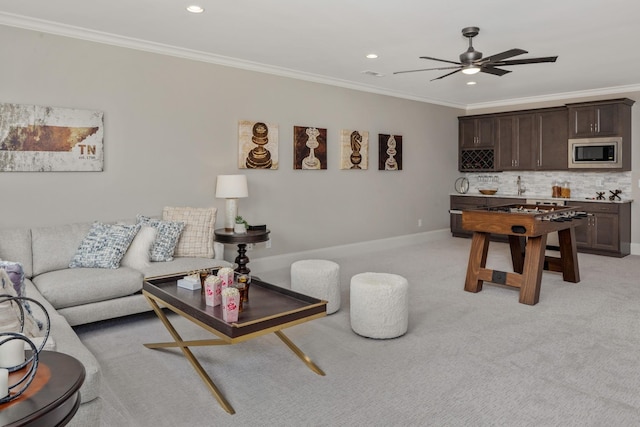 carpeted living room featuring crown molding and ceiling fan