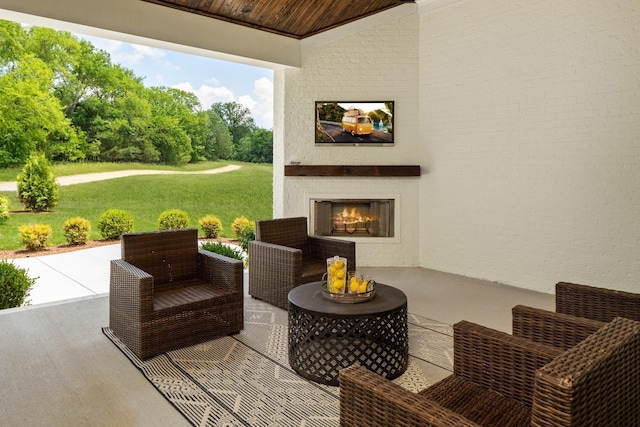 view of patio with an outdoor living space with a fireplace