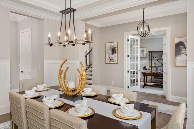 dining room featuring ornamental molding, dark wood-type flooring, and a chandelier