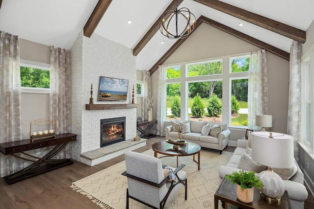 living room with beam ceiling, an inviting chandelier, high vaulted ceiling, wood-type flooring, and a fireplace