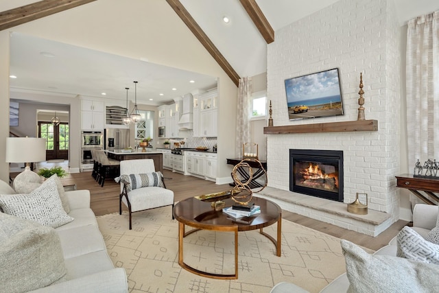 living room featuring beam ceiling, a fireplace, high vaulted ceiling, and light hardwood / wood-style flooring