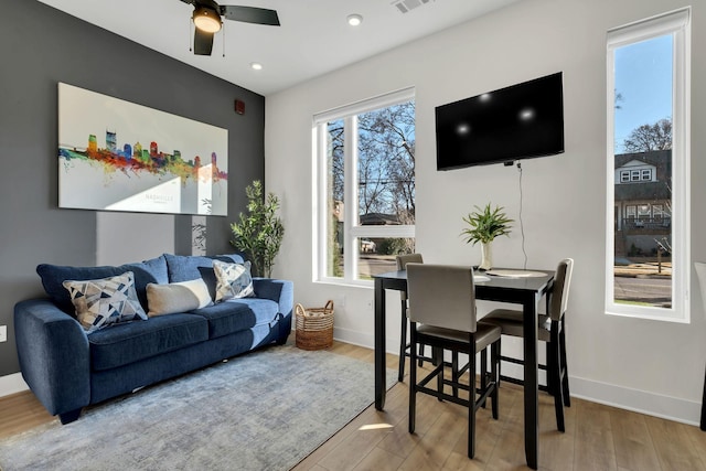 living room with hardwood / wood-style floors and ceiling fan