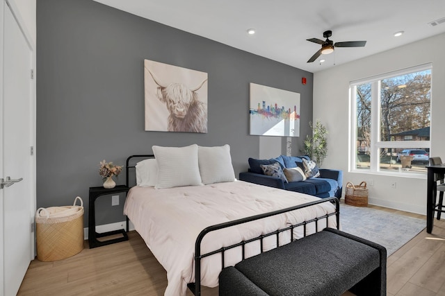 bedroom with light hardwood / wood-style floors and ceiling fan