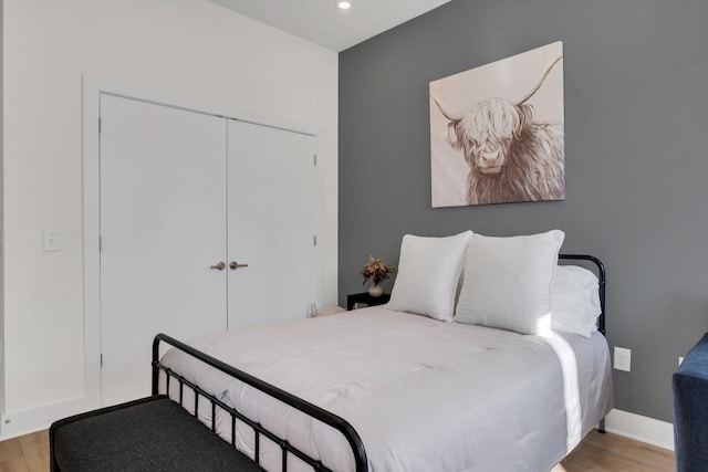 bedroom featuring light hardwood / wood-style floors and a closet