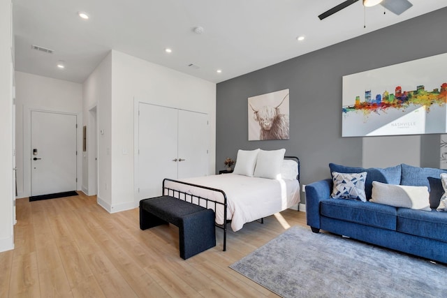 bedroom featuring a closet, light hardwood / wood-style floors, and ceiling fan