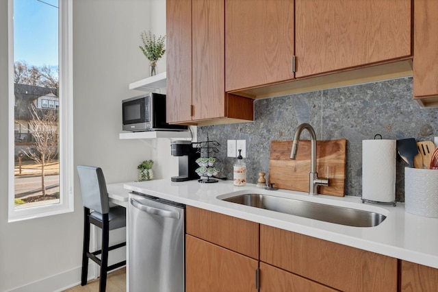 kitchen with decorative backsplash, sink, and appliances with stainless steel finishes