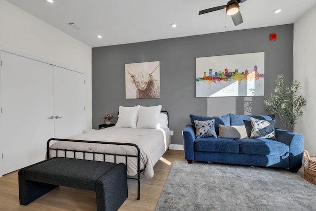 bedroom featuring ceiling fan, wood-type flooring, and a closet