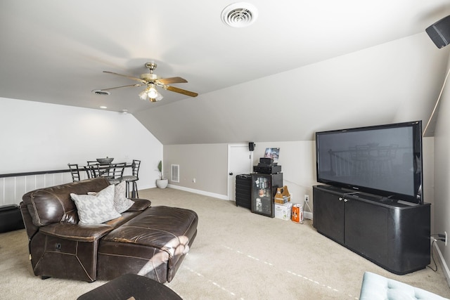 living room with vaulted ceiling, light colored carpet, and ceiling fan