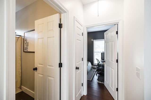 hallway with dark hardwood / wood-style floors