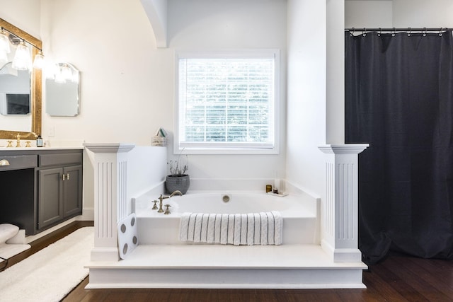 bathroom featuring a tub to relax in, vanity, and hardwood / wood-style floors