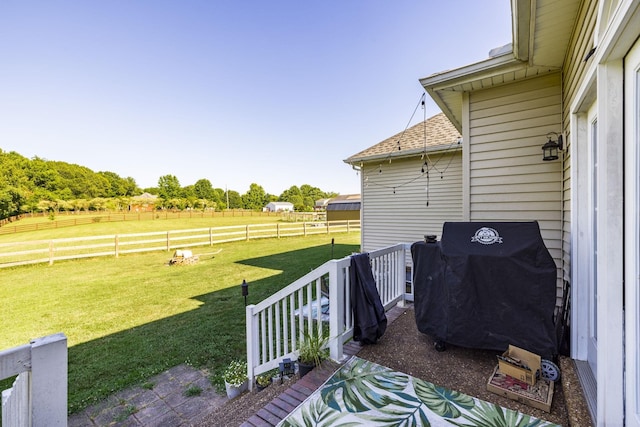 view of patio / terrace with a grill and a rural view