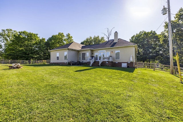 back of house featuring a lawn and french doors