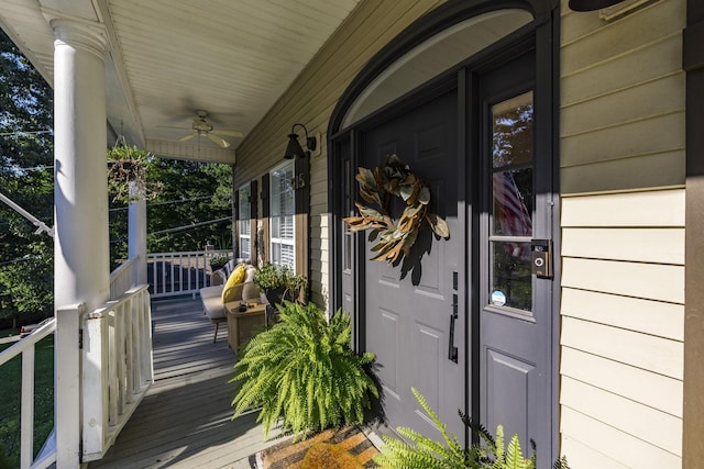 entrance to property featuring ceiling fan and covered porch