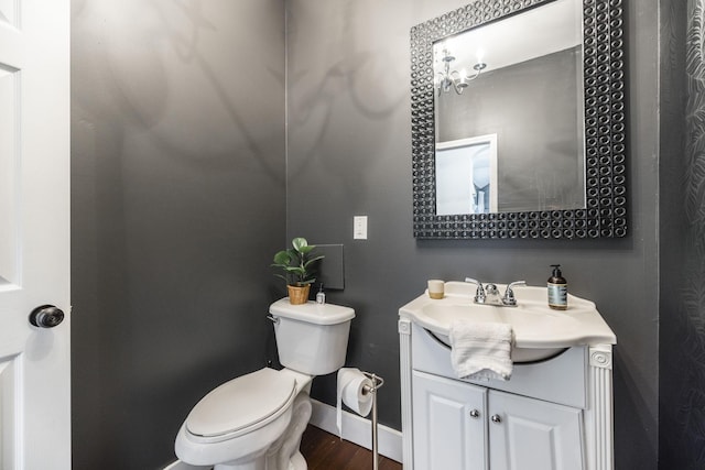 bathroom featuring vanity, hardwood / wood-style floors, and toilet