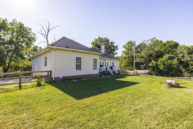 rear view of property featuring a yard