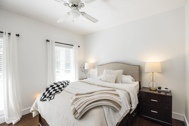 bedroom with dark hardwood / wood-style floors and ceiling fan