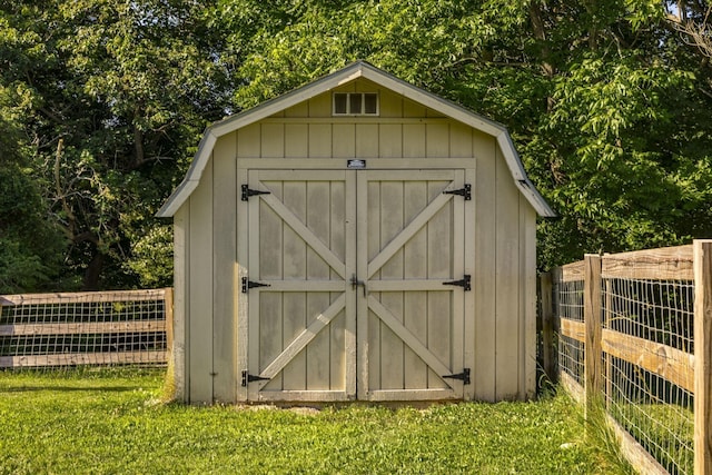 view of outdoor structure featuring a lawn