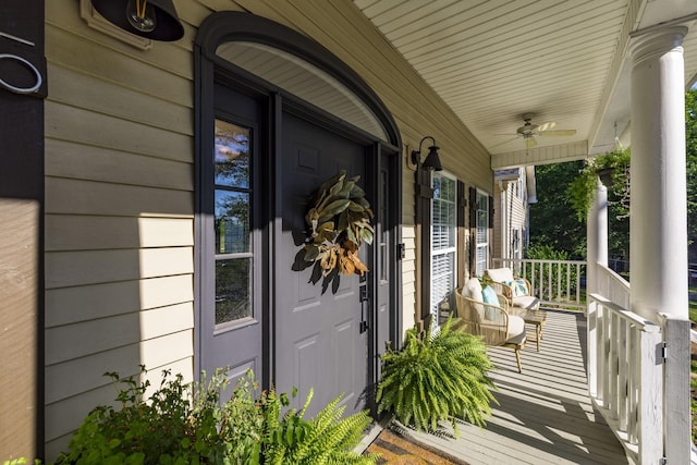 entrance to property featuring ceiling fan and covered porch