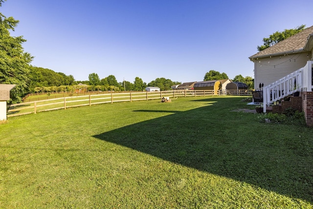 view of yard with a rural view