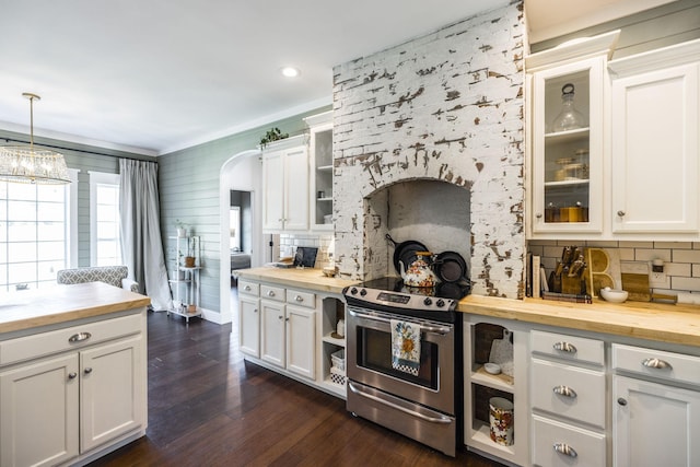 kitchen featuring electric stove, wooden counters, white cabinetry, decorative backsplash, and decorative light fixtures