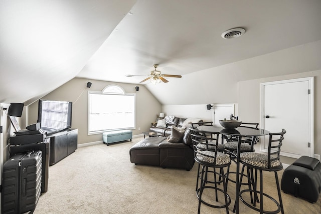 living room with carpet, ceiling fan, and vaulted ceiling