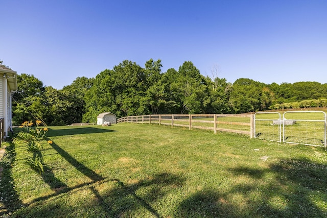 view of yard featuring a rural view and a storage unit