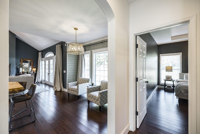 interior space featuring a notable chandelier, dark hardwood / wood-style flooring, and lofted ceiling