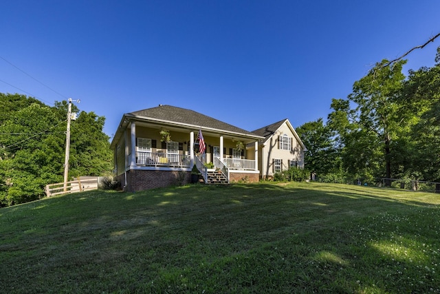 view of front of property with a porch and a front lawn